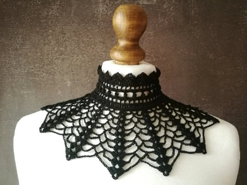 May include: A black crocheted lace collar with a scalloped edge.