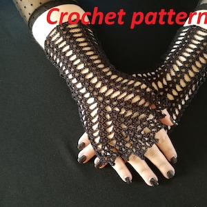 May include: A pair of black crochet fingerless gloves with a lacy pattern. The gloves are shown against a black background. Crochet pattern.