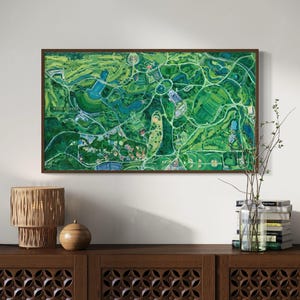 The vibrantly green and colorful Forest Park painting framed on wall in home interior setting above a wooden console with rustic, natural accents.