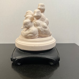 Vintage ceramic ducks on a black pedestal