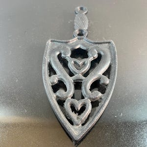 vintage black metal iron trivet