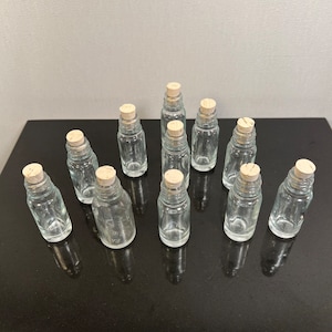 Small glass jars with corks stoppers
