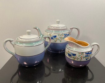 Vintage porcelain teapot with creamer and sugar