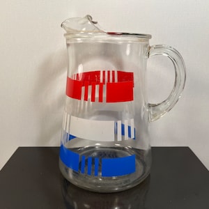 Vintage clear glass pitcher with red white and blue stripes