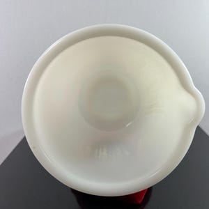 May include: White ceramic mixing bowl with a slightly flared rim and a pouring spout. The bowl is empty and appears to be in good condition.