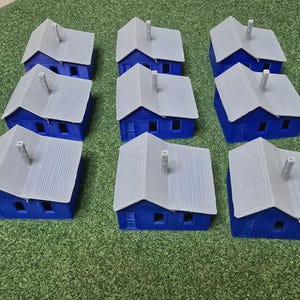 May include: Ten miniature blue and white houses with gray roofs. The houses are made of plastic and are about 2 inches tall.