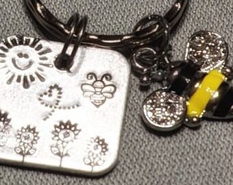 Silver keychain, flowers, sun, bees, butterfly, hand-stamped on metal