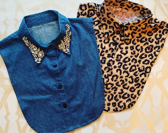 May include: Two detachable shirt collars. One is blue denim with clear crystal embellishments on the collar points and a button-down front. The other features a tan and black leopard print pattern with a button-down front. Both have Kay & Jerry labels.