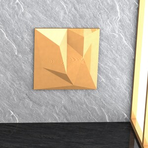 May include: A geometric wall sculpture made of wood with a light brown finish. The sculpture has a three-dimensional design with sharp angles and edges.