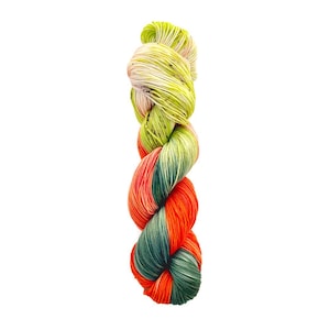 May include: A skein of hand-dyed yarn in a vertical composition. The yarn is a blend of colors, including lime green, white, orange, and dark green. The yarn is twisted and appears soft, suitable for knitting or crochet projects.