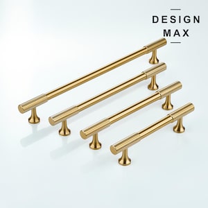 May include: Four gold cabinet pulls with a textured design. The pulls are arranged in a row from largest to smallest.