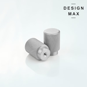 May include: Two silver metal cabinet knobs with a textured diamond pattern. The knobs are cylindrical in shape and have a threaded hole on the bottom.