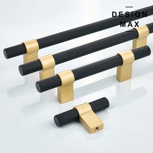 May include: Four black and gold cabinet pulls with a textured finish. The pulls are in various sizes and shapes. The largest pull is 12 inches long. The smallest pull is a 3-inch T-shaped pull. The pulls are labeled "DESIGN MAX".