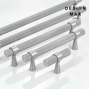 May include: Five silver cabinet pulls with a textured diamond pattern. The pulls are in various sizes and styles, including a small knob and longer bar pulls. The pulls are labelled "DESIGN MAX".
