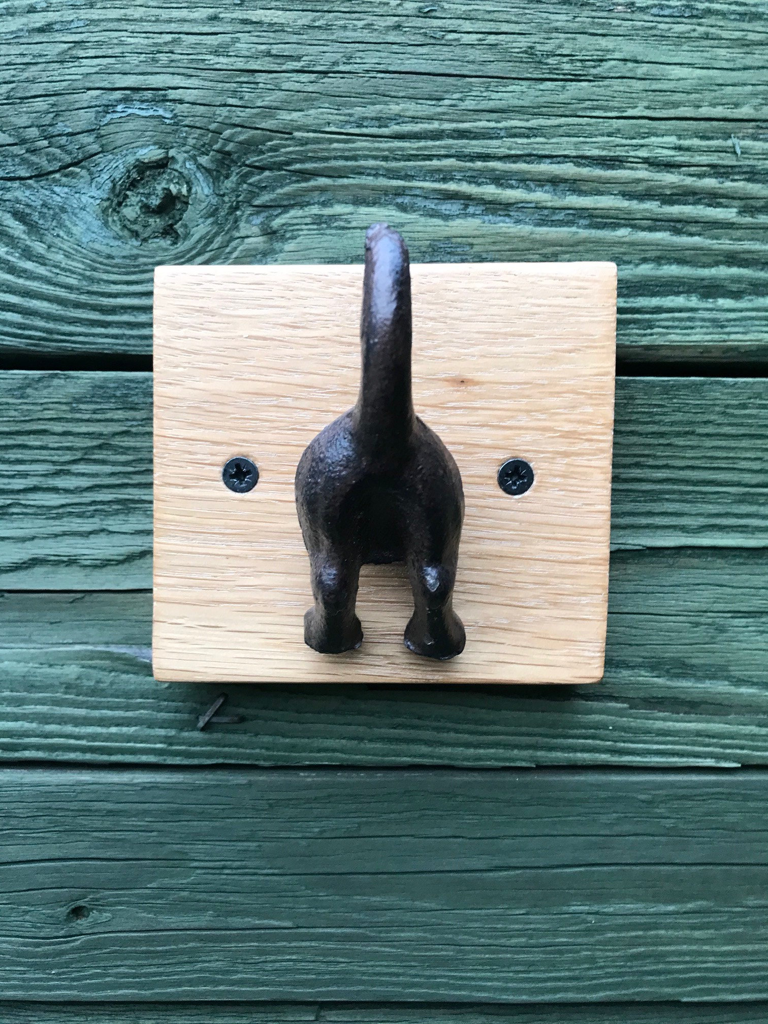 Cast iron dog tail hooks on a waxed oak plinth Etsy.de
