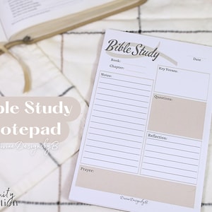 May include: A white notepad with the text "Bible Study" in brown lettering. The notepad has sections for notes, key verses, questions, reflection, and prayer.