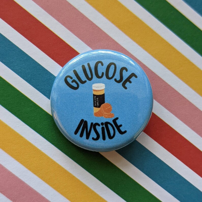 May include: A blue button with the text "GLUCOSE INSIDE" in black. A cartoon illustration of a bottle of glucose tablets is inside the text.
