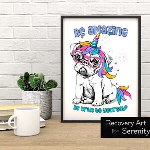 May include: A framed print with a white background featuring a cartoon pug with a unicorn horn and rainbow mane wearing pink glasses. The text "Be amazing" is above the pug and "Be true to yourself" is below. The print is titled "Recovery Art from Serenity Press".
