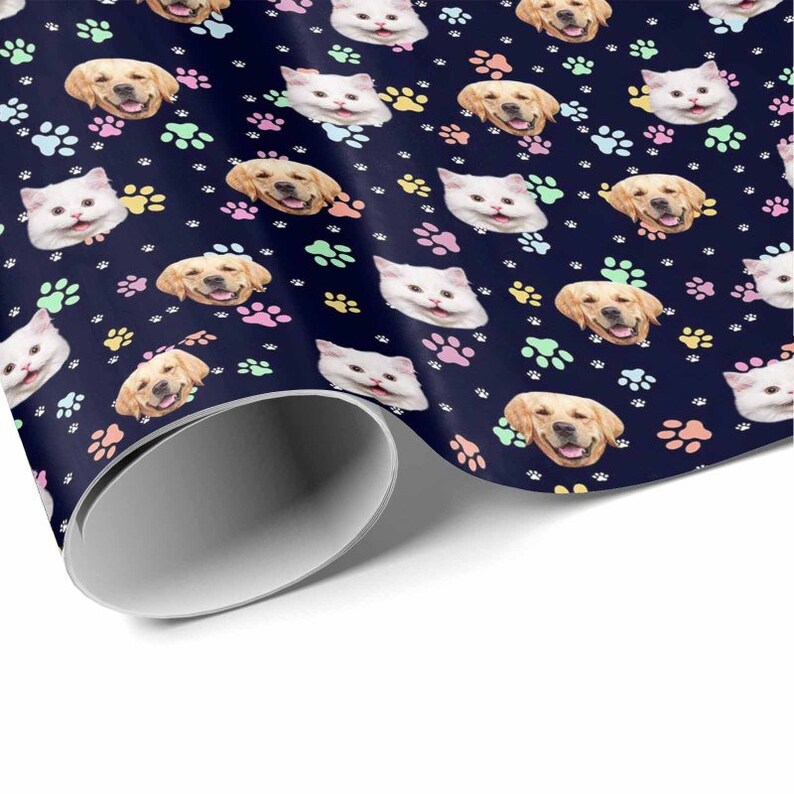 May include: A dark blue wrapping paper with a repeating pattern of paw prints and the faces of dogs and cats. The paw prints are in various pastel colors.
