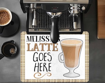 May include: A white kitchen mat with a brown plaid border. The mat has the text "Melissa's Latte Goes Here" in black lettering and a cartoon image of a latte in a glass.