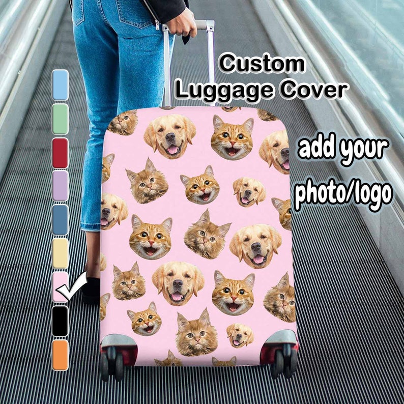 May include: A pink custom luggage cover with a repeating pattern of smiling cat and dog faces. The cover has the text "Custom Luggage Cover" and "add your photo/logo" in white. The luggage is being pulled on a moving walkway.