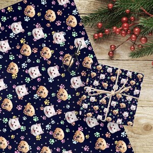 May include: A blue wrapping paper with a repeating pattern of paw prints, cats, and dogs. The cats and dogs have different colored collars. The wrapping paper is shown wrapped around a gift box.