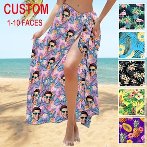 May include: A pink sarong with a tropical print featuring multiple faces. The sarong is tied at the waist and has a slit on the side. The text "CUSTOM 1-10 FACES" is visible in the top left corner of the image.