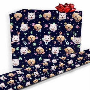 May include: Blue wrapping paper with a repeating pattern of paw prints, cat faces, and dog faces. The paper is wrapped around a gift box with a red bow.
