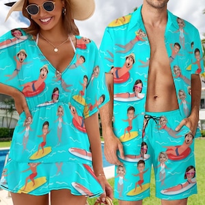 May include: A matching set of blue and white beachwear with a fun, colorful pattern of people surfing and swimming. The set includes a short-sleeved shirt and a pair of swim trunks.