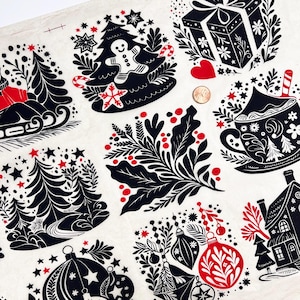 May include: A fabric featuring a repeating Christmas pattern. The design includes black and red illustrations of Christmas trees, gingerbread men, ornaments, gifts, and mugs on a white background.