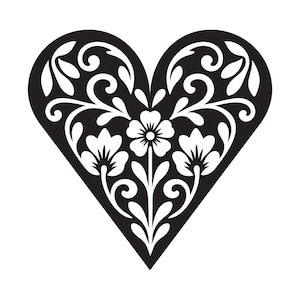 May include: A black heart-shaped cutout featuring a white floral pattern. The design includes three central flowers with stems and leaves, surrounded by symmetrical swirling vine motifs that fill the interior space of the heart shape.