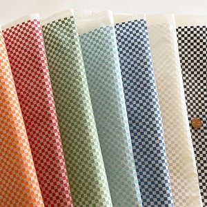 May include: Assortment of eight checkered tissue paper sheets in various colours, including orange, red, green, blue, white, and black.