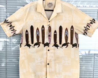 May include: A yellow short-sleeved button-down shirt with a pattern of surfboards and sea turtles. The shirt has a white background with a brown and green pattern. The shirt has a button-down collar and a button-up front.