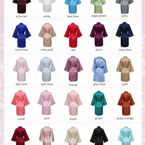 May include: A chart showing 25 different colors of satin robes. The robes are arranged in five rows of five, with each row representing a different color. The colors include wine red, white, teal blue, sage green, grey, royal blue, rose gold, red, plum, navy blue, light pink, light blue, mauve, grey blue, gold, coral, pink, blush, green, dusty orange, burgundy, nude pink, champagne, black, and aqua blue.