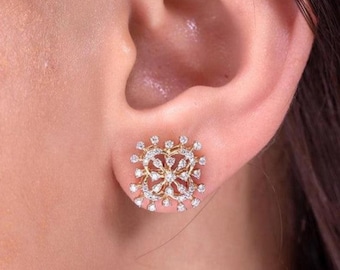 May include: A pair of gold earrings with a square-shaped design featuring a cluster of small diamonds.
