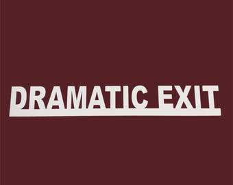 May include: White sign with the words "DRAMATIC EXIT" in capital letters. The sign is on a dark red background. The text is in a sans-serif font.