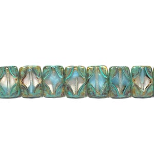 May include: A strand of turquoise and silver-colored beads. Each bead is rectangular with a diamond-shaped design in the center. The beads have a metallic sheen and are strung together, creating a decorative element.
