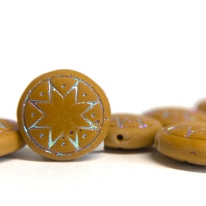May include: A group of brown ceramic beads with a star design. The beads have a iridescent finish.