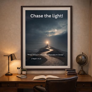 May include: Framed artwork with the text "Chase the light!" and a quote from 2 Nephi 31:20. The image depicts a path leading to a bright light under a cloudy sky. The artwork is displayed on a wooden desk with a lamp and books.