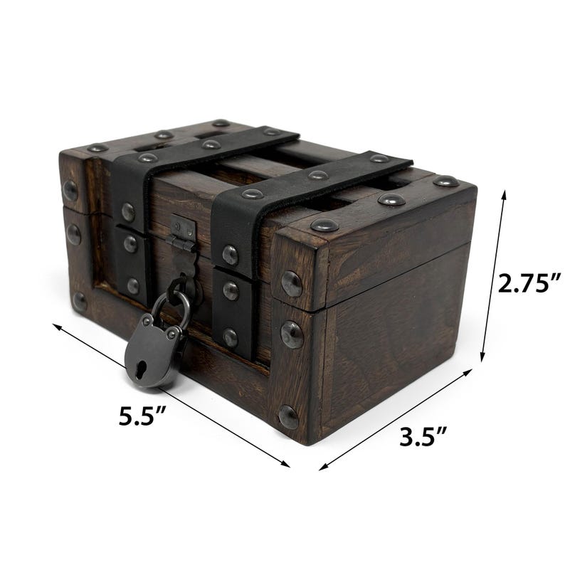 May include: A small, dark wooden chest with metal accents and a padlock. The chest measures 5.5 inches long, 3.5 inches wide, and 2.75 inches high. It features black metal straps and rivets, giving it a vintage or antique appearance.