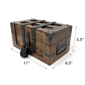 May include: A wooden treasure chest with metal accents and a black padlock. The chest is 11 inches long, 6.5 inches wide, and 5.5 inches high. It features metal straps and corner reinforcements, and a handle on the side.