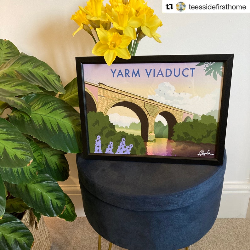 May include: A framed print of a colourful illustration of the Yarm Viaduct, a stone bridge over a river. The print is in a black frame and has the title "Yarm Viaduct" in white text at the top. The artist's signature is in the bottom right corner.