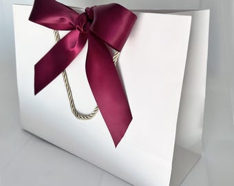 White Gift Bag: Wide Wine Satin Ribbon and Gold Cords (13.75x11.75 4-1/8 inch)