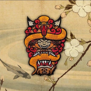 May include: A red and orange embroidered patch depicting a snarling mythical creature with a snake-like body and a dragon-like head. The creature is surrounded by red and orange clouds.