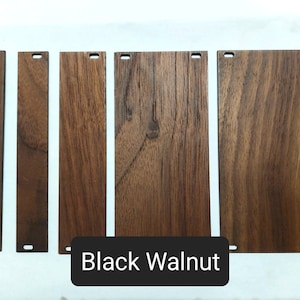 May include: Five wood samples of black walnut, each with a different grain pattern. The samples are arranged horizontally, with the text "Black Walnut" below them.