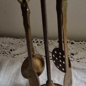 Vintage mini brass carousel with kitchen utensils