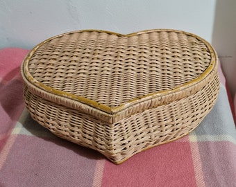Vintage pink toned cane heart shaped sewing box.