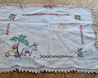 Vintage cream doilie with embroided mexican motif with donkey.