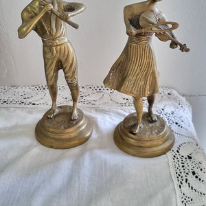 Set of two musical instrument playing brass figurines