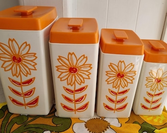 Juego vintage de cuatro botes Nylex con diseño de girasol.